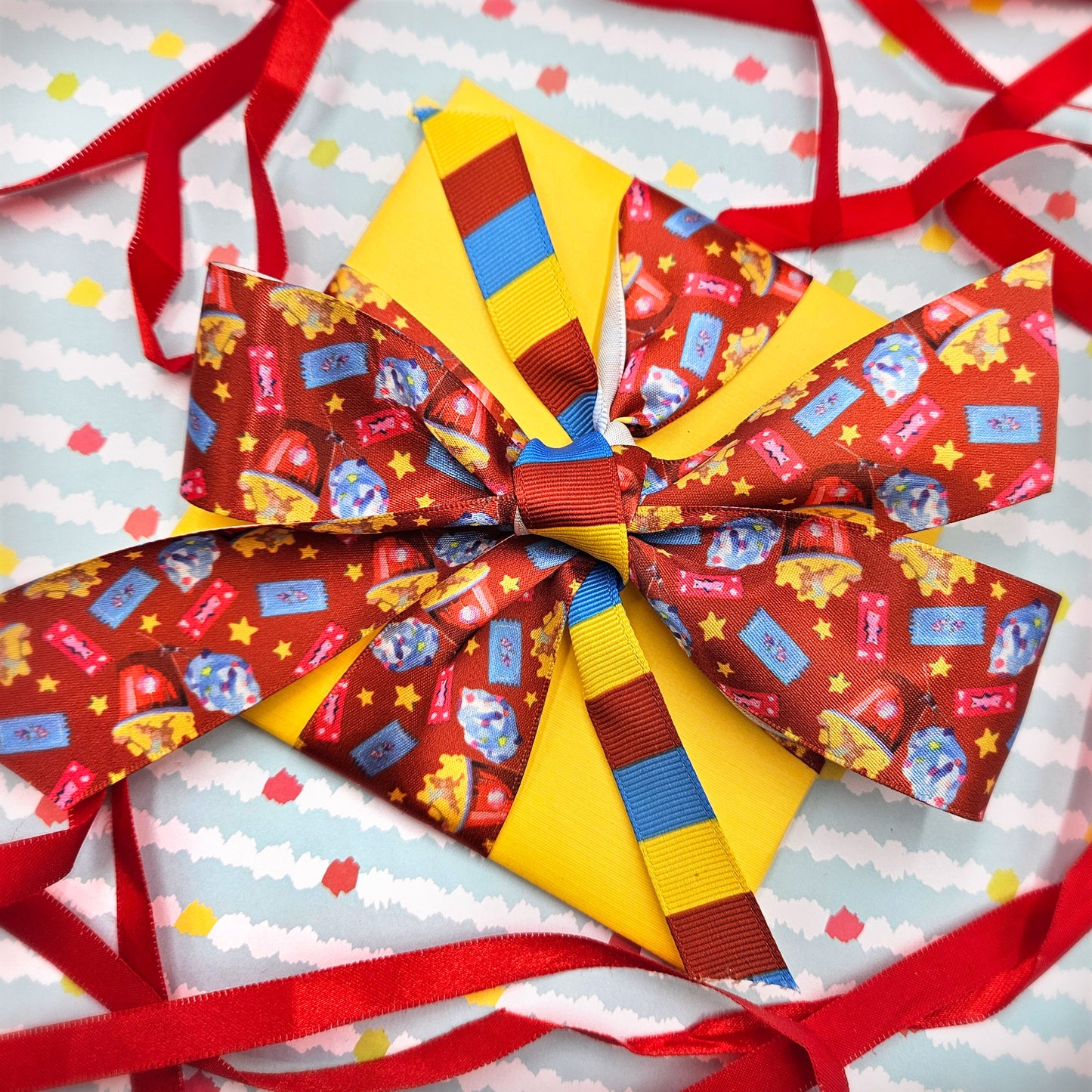 Popcorn ribbon with cotton candy, carnival tickets and yellow stars printed on 7/8" and 1.5" white single face satin