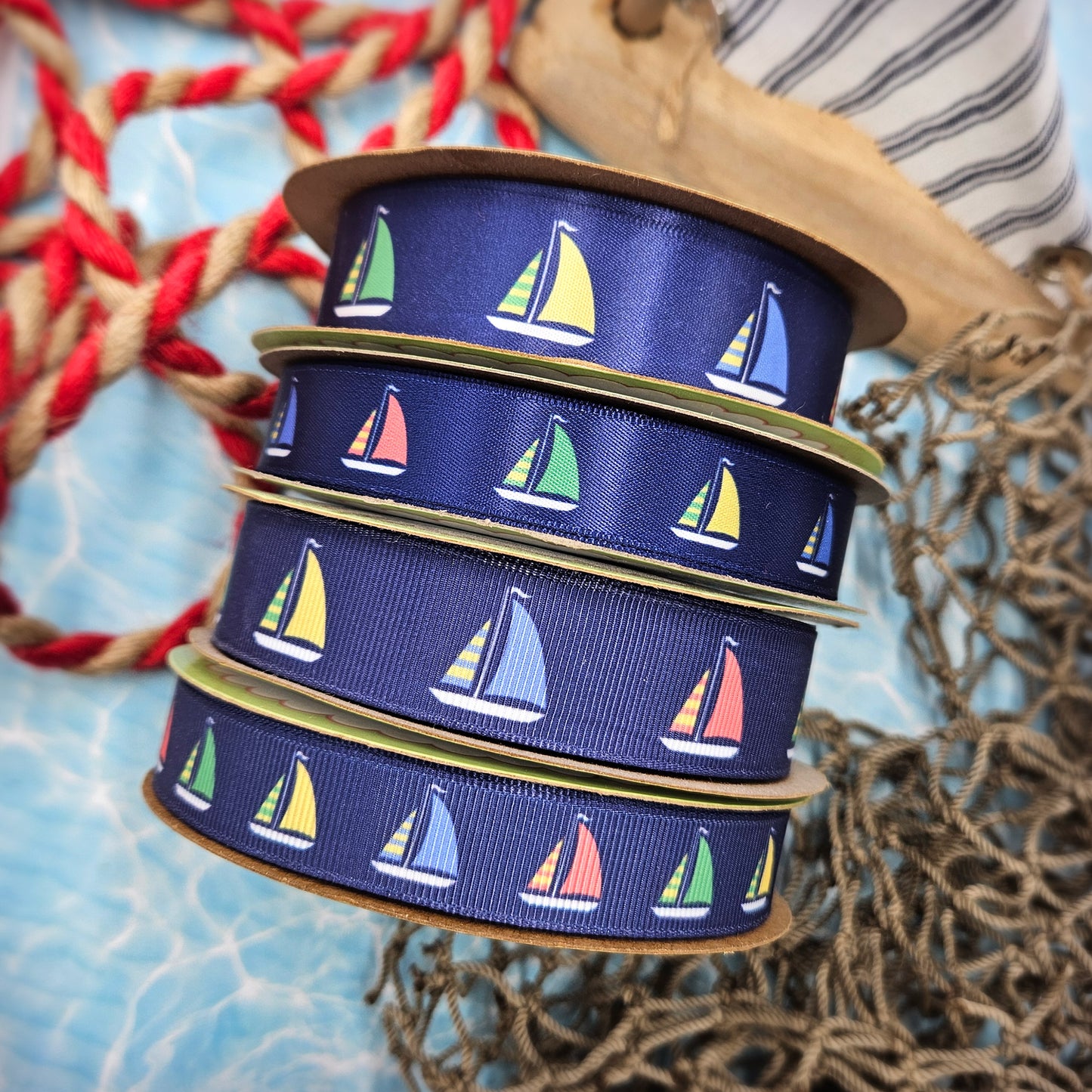 Sailboat ribbon with sales of green, yellow, blue and red printed on 5/8" and 7/8" satin and grosgrain