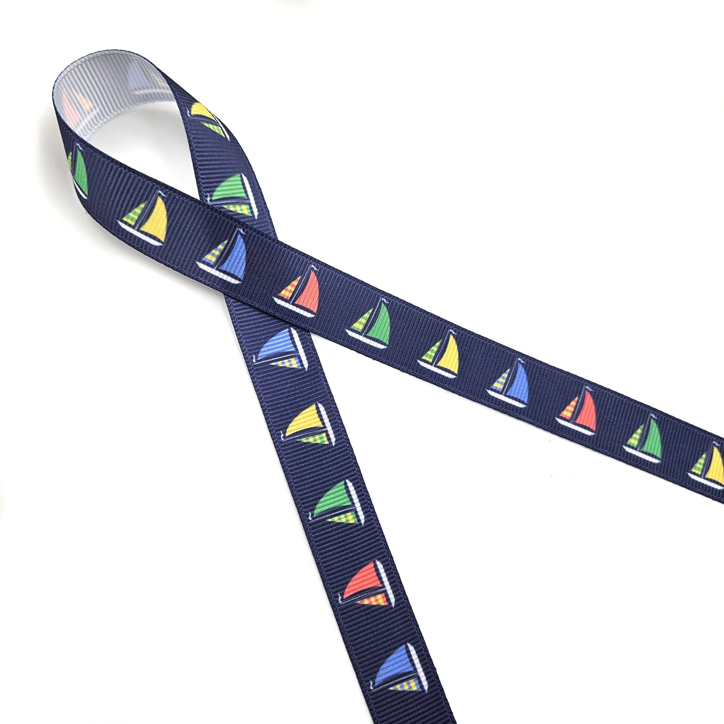 Sailboat ribbon with sales of green, yellow, blue and red printed on 5/8" and 7/8" satin and grosgrain