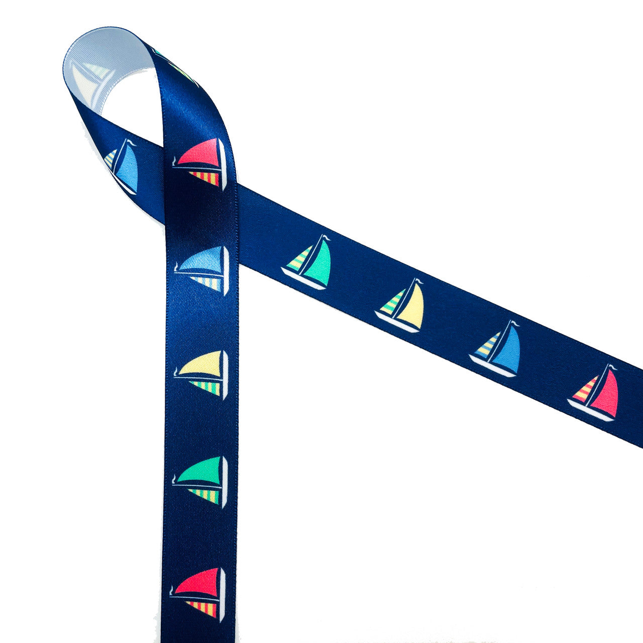 Sailboats with colorful billowing sails on a navy blue background printed on 7/8" white single face satin ribbon is a must for Summer seaside and lake side soirees! This is an ideal ribbon for gift wrap, party decor, favors and Summer crafting! All our ribbon is designed and printed in the USA!