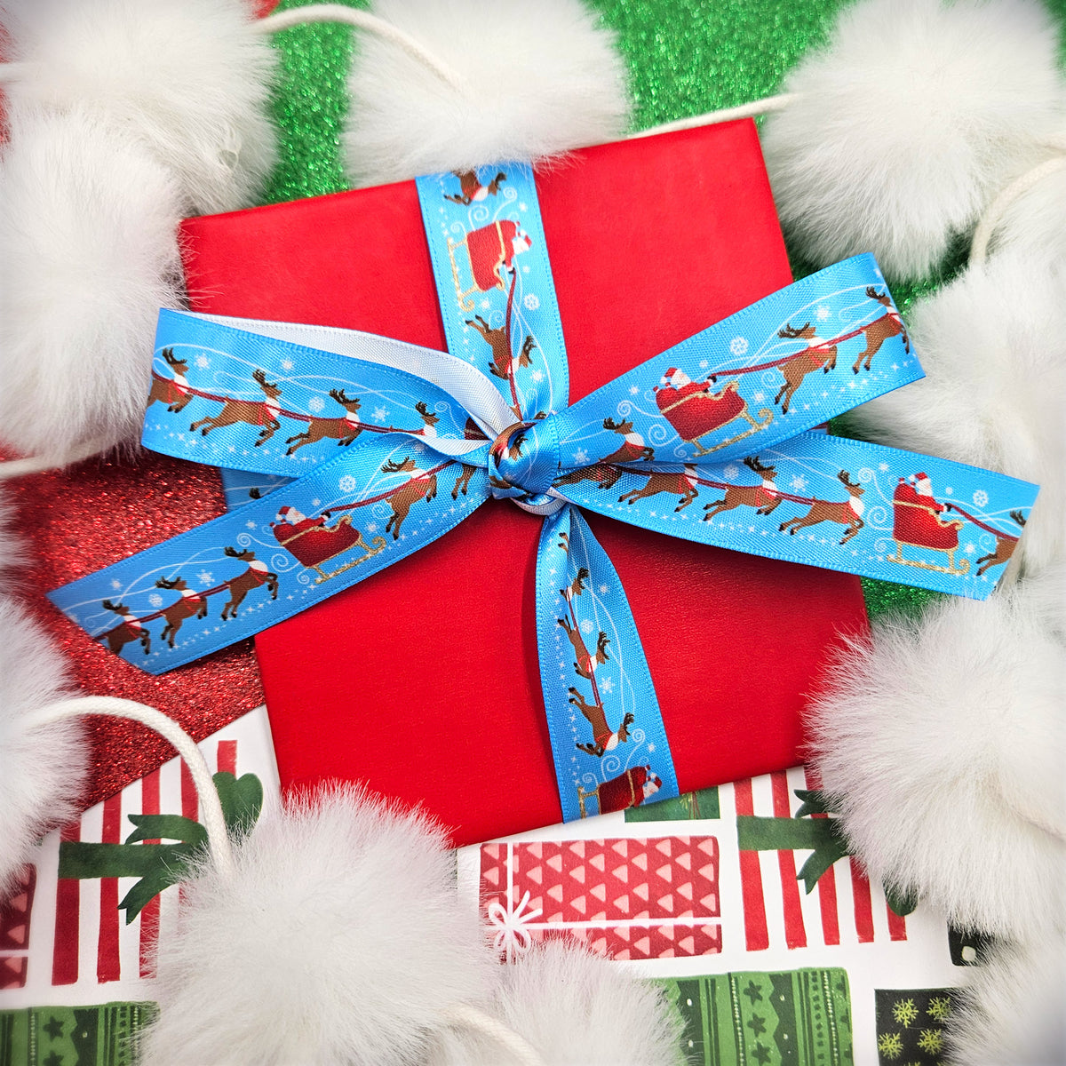 Christmas ribbon Santa with eight tiny reindeer and his sleigh on a light blue background printed on 5/8" and 7/8" satin