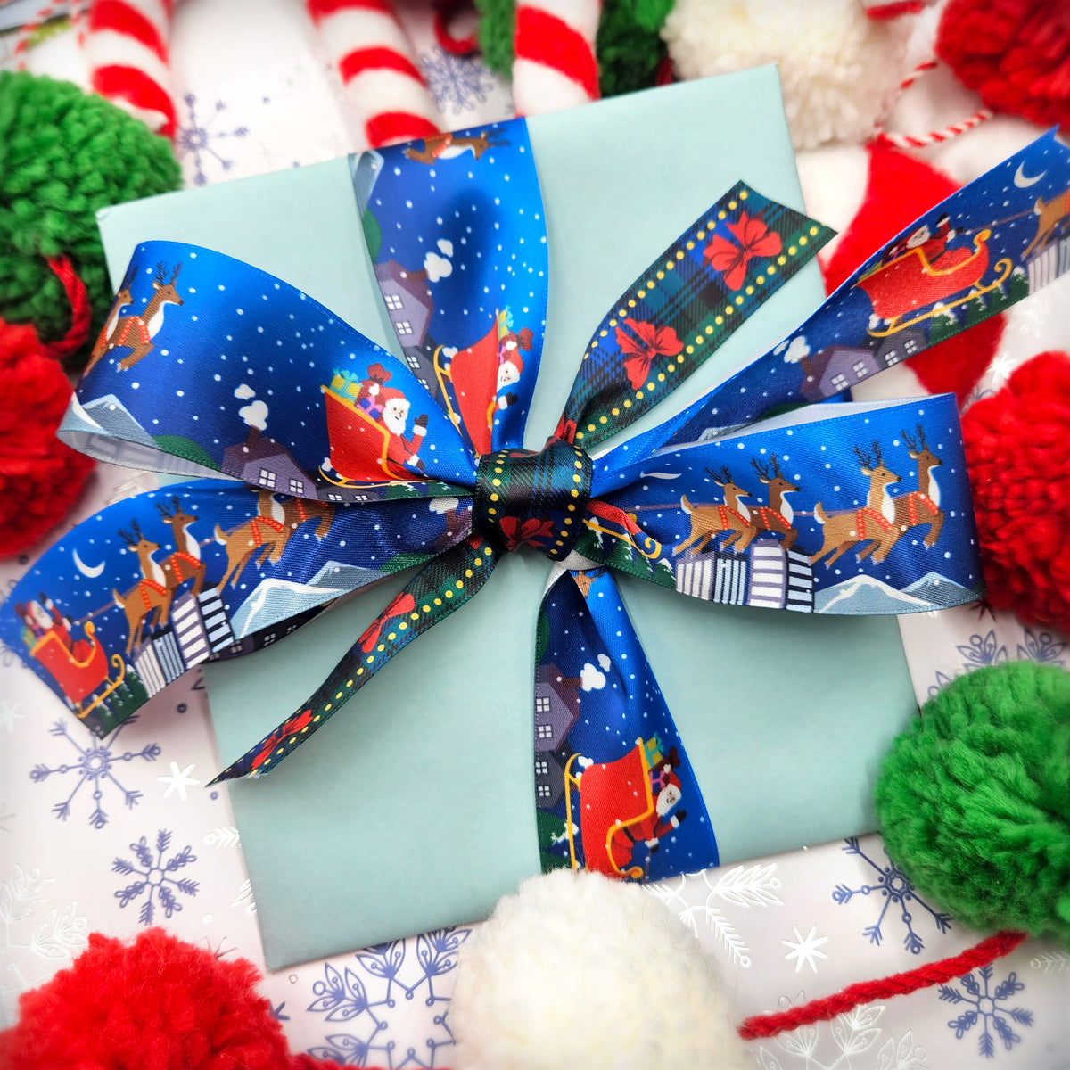 Santa and his sleigh with reindeer Christmas on a blue background printed on 1.5" white satin ribbon