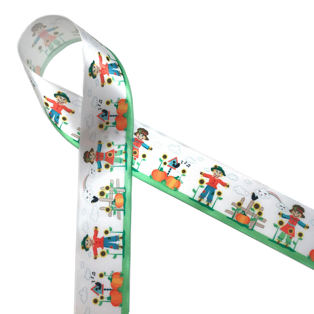 Our widest Scarecrow ribbon  printed on 1.5" single face satin features scarecrows with red jackets and blue pants in a garden of pumpkins and sunflowers with adorable little birdhouses. This sweet ribbon is perfect for Fall decor, wreaths and crafts. Be sure to add this ribbon to your Fall collection. Our ribbon is Designed and printed in the USA