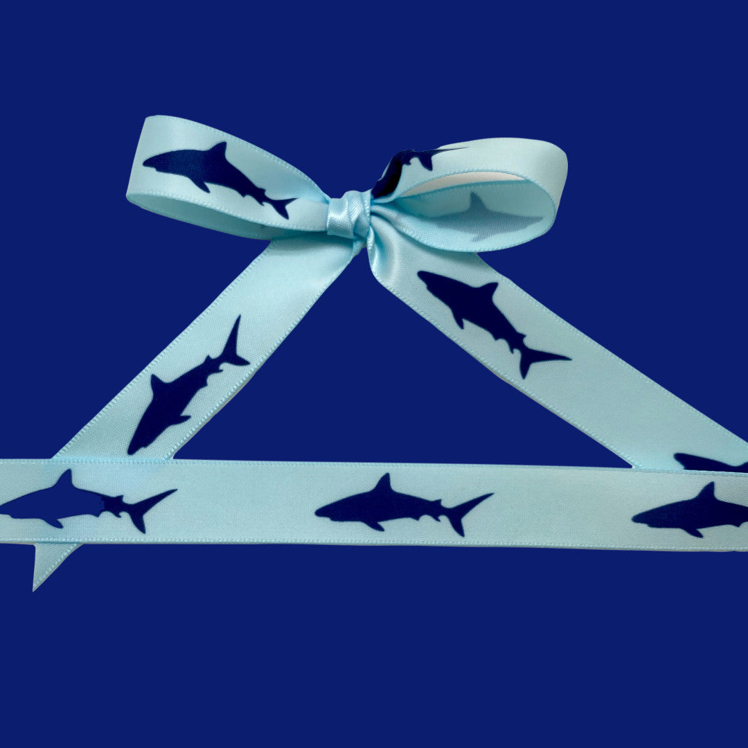 Tie a pretty bow with our shark ribbon to create the perfect topping to a party favor!