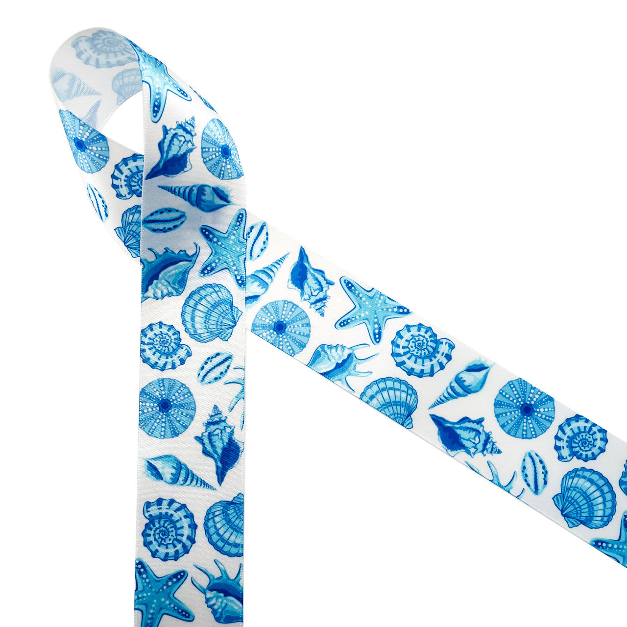 Seashells in blue printed on 1.5" white single face satin ribbon is  the ideal ribbon for Summer weddings, parties, home decor, gift wrap and quilting projects. This beautiful ribbon will make a big impact on all your Summer soirees! All our ribbon is designed and printed in the USA