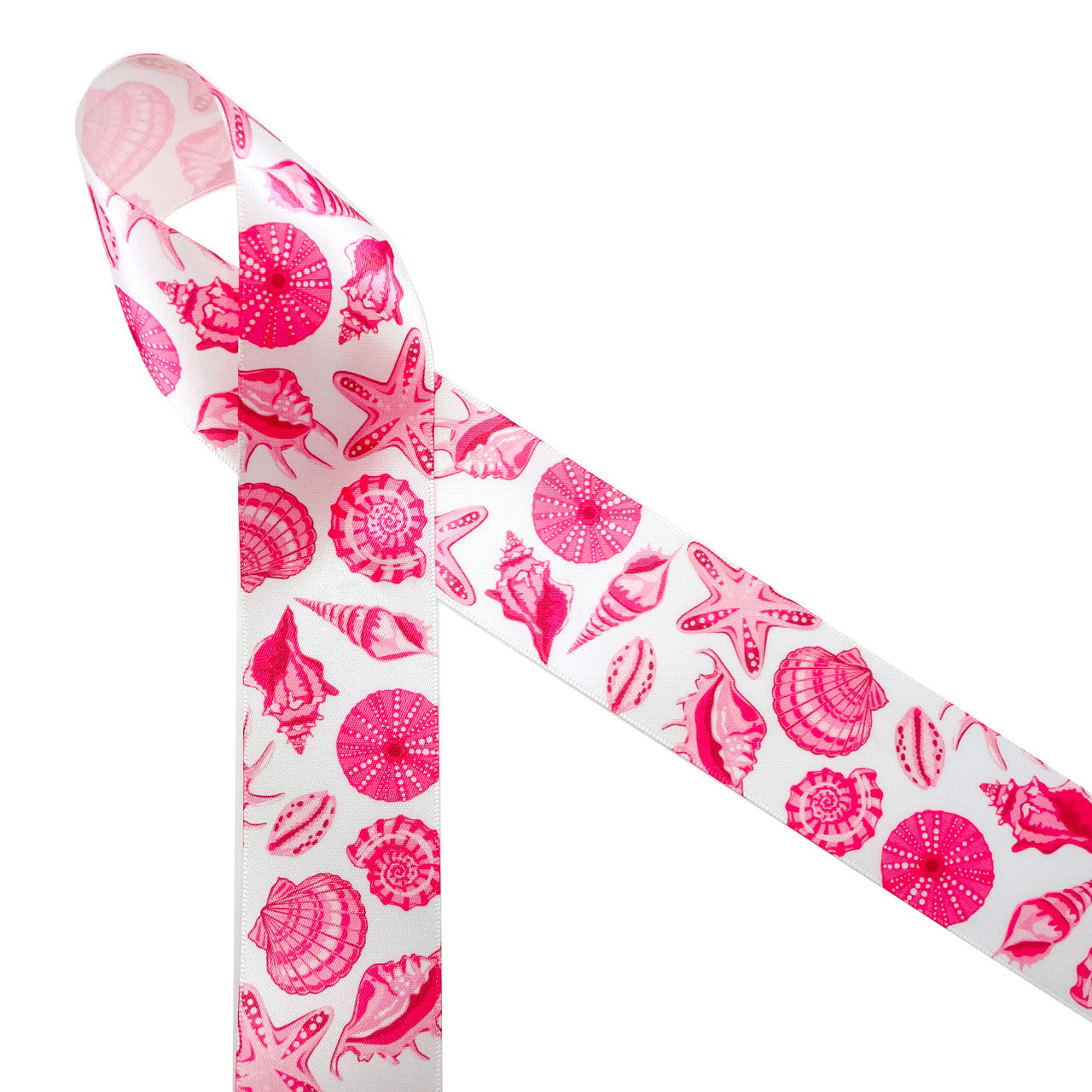 Seashells in pink printed on 1.5" white single face satin ribbon is  the ideal ribbon for Summer weddings, parties, home decor, gift wrap and quilting projects. This beautiful ribbon will make a big impact on all your Summer soirees! All our ribbon is designed and printed in the USA