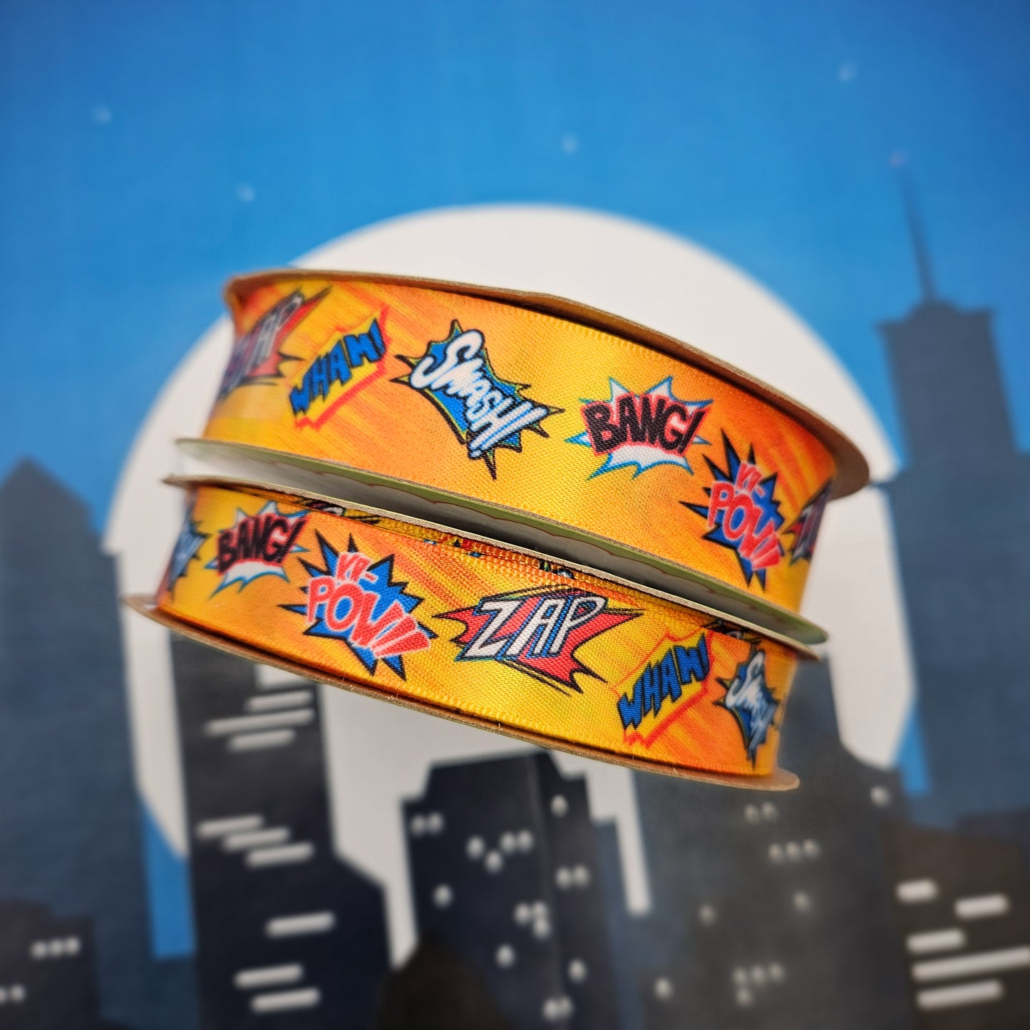 Super Hero Ribbon Zap, Pow, Bang, Smash, Wham on a bright orange background printed on 5/8" and 7/8" single face satin