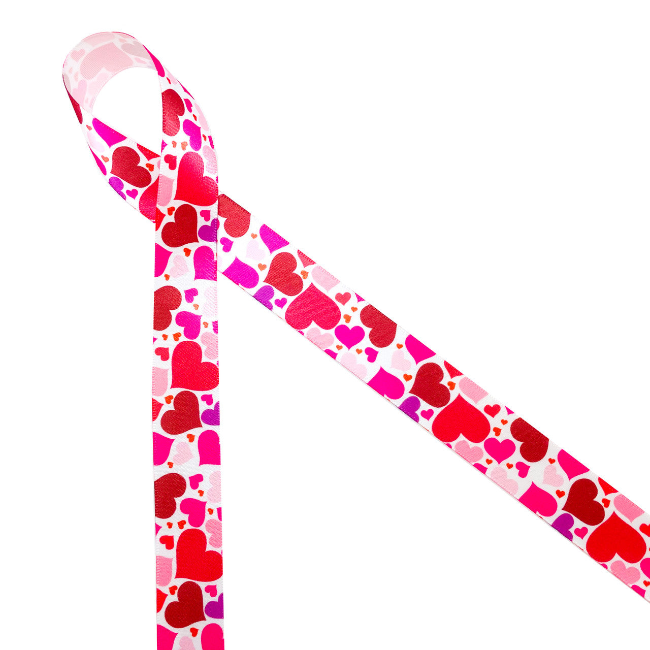 Tossed hearts in pink and red on 7/8" white single face satin  ribbon is such a fun design for Valentine's Day. This is a great ribbon for gift wrap, party decor, scrapbooking and craft projects with a love theme! Be sure to have this versatile ribbon on hand for your Valentine needs! All our ribbon is designed and printed in the USA