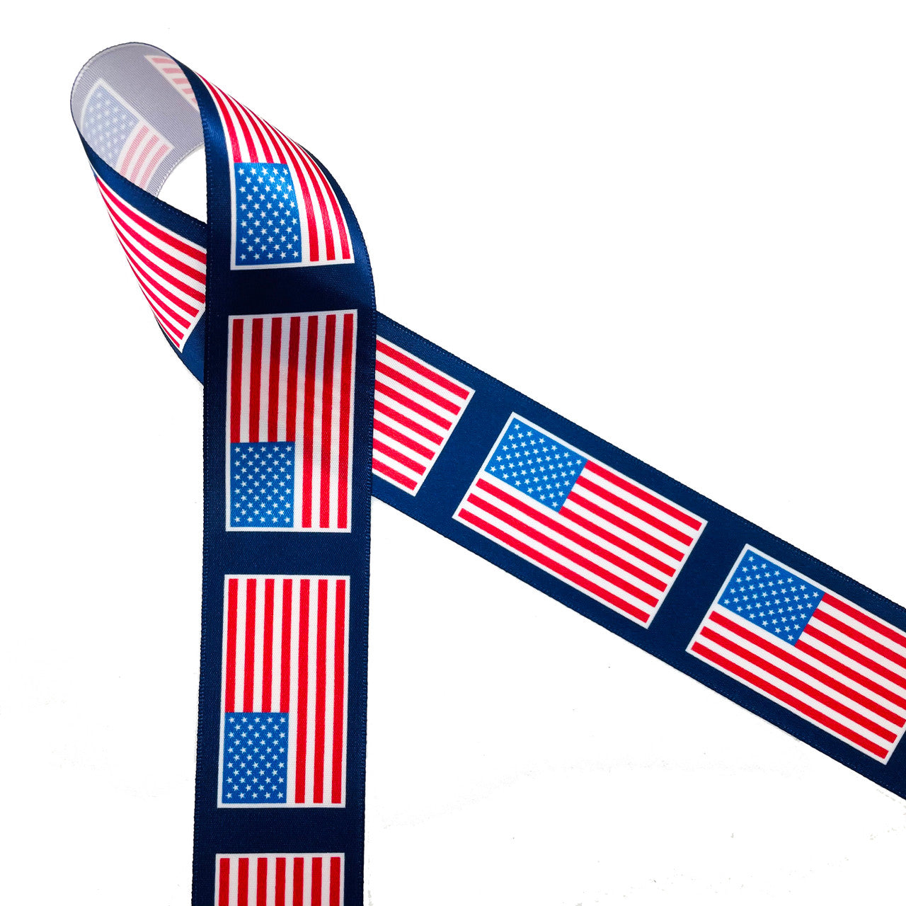 American Flags line up on a navy blue background printed on 1.5" white satin ribbon for the perfect patriotic ribbon! This is an ideal ribbon for 4th of July, Memorial Day and Veterans Day. Use this ribbon for hair bows, wreaths, party decor and gift wrap for the biggest Summer holiday! All our ribbon is designed and printed in the USA