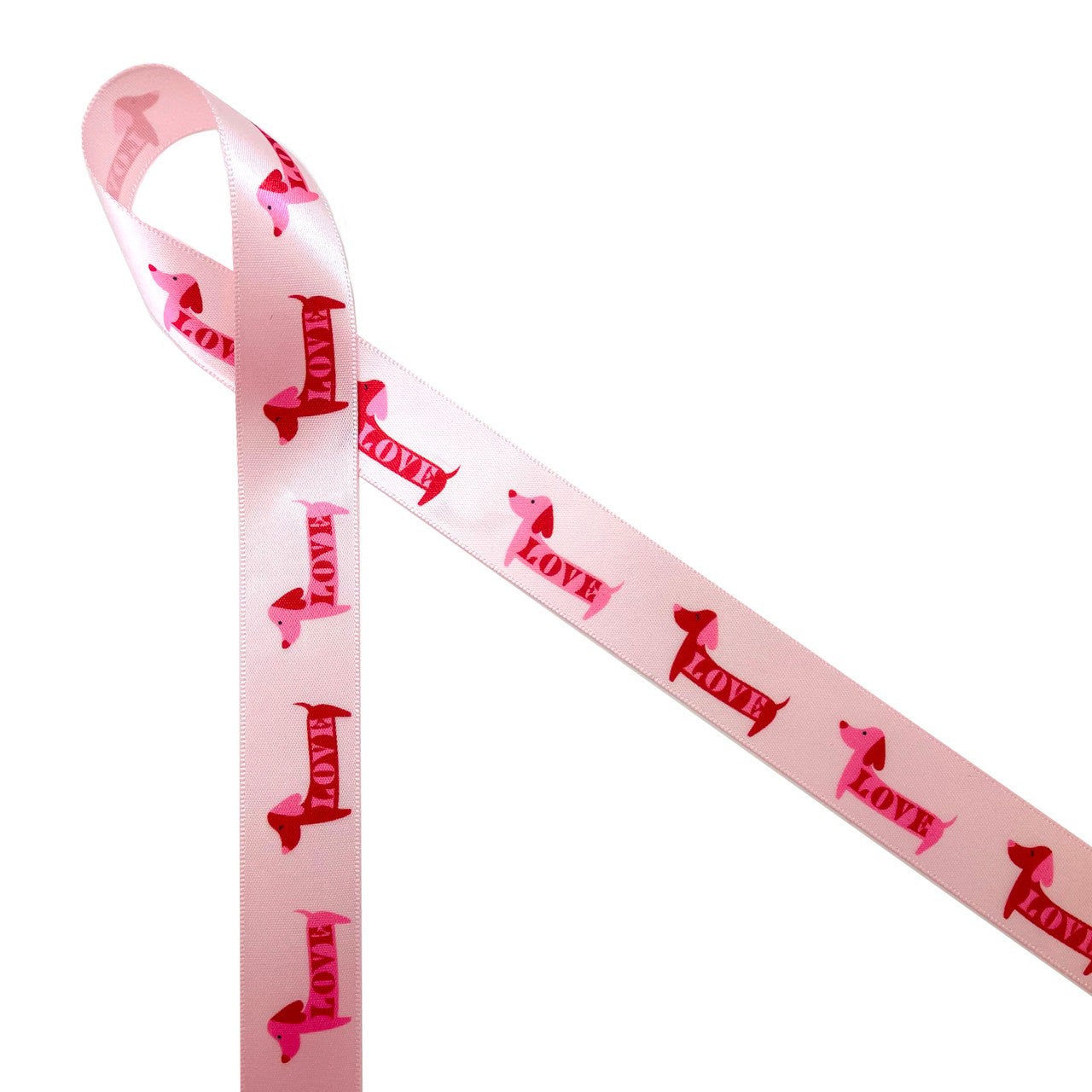 Puppy love ribbon with dachshund wiener dogs in pink and red printed on 7/8" light pink single face satin ribbon is an adorable ribbon for Valentine's Day. This sweet ribbon is perfect for gift wrap, gift baskets, pet gifts, Valentine favors, party decor, candy shops and  chocolatiers. This is also a sweet ribbon for pet loss and remembrance. All our ribbon is designed and printed in the USA