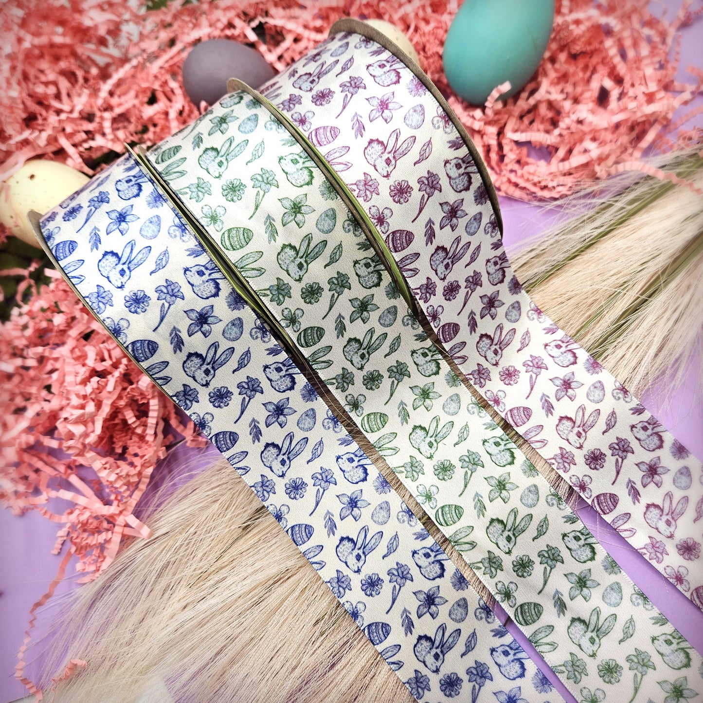 Easter Toile ribbon with bunnies, flowers, eggs and leaves in three colors raspberry, green and blue printed on 1.5" satin