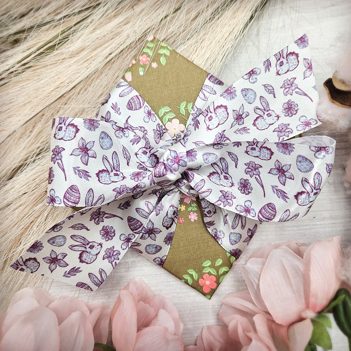 Easter Toile ribbon with bunnies, flowers, eggs and leaves in three colors raspberry, green and blue printed on 1.5" satin