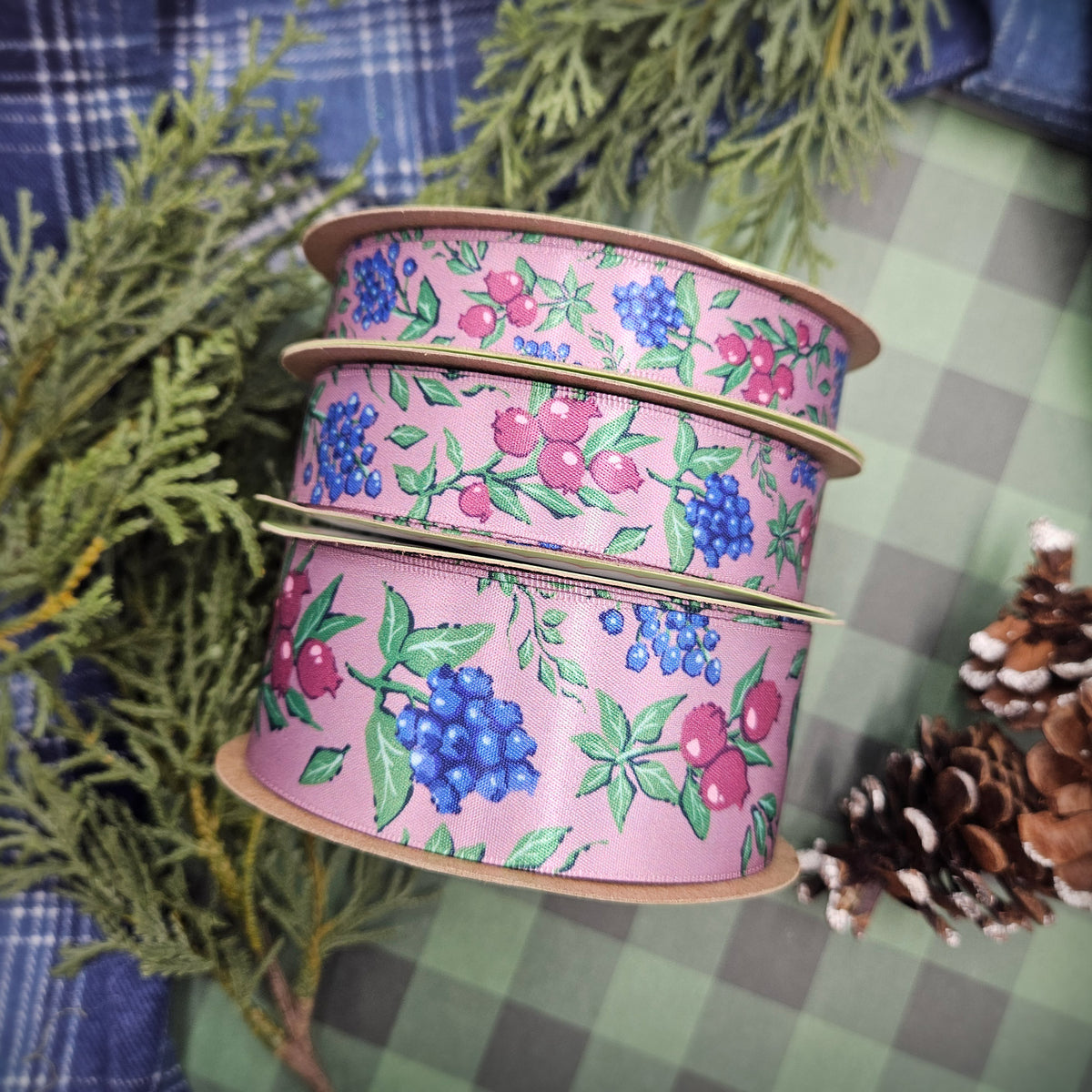 Winter berries ribbon berries in blue, green and deep pink on a mauve background offered in 5/8", 7/8" and 1.5" widths