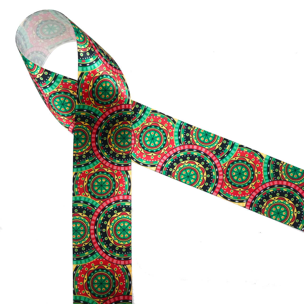 African tribal medallion print in pink, green, black and yellow printed on 1.5" white single face satin ribbon is an ideal ribbon for  hair bows, head bands, gift wrap, Kwanza, festivals and cultural celebrations. Be sure to have this ribbon on hand for crafts, quilting, sewing and craft projects. All our ribbons are designed and printed in the USA