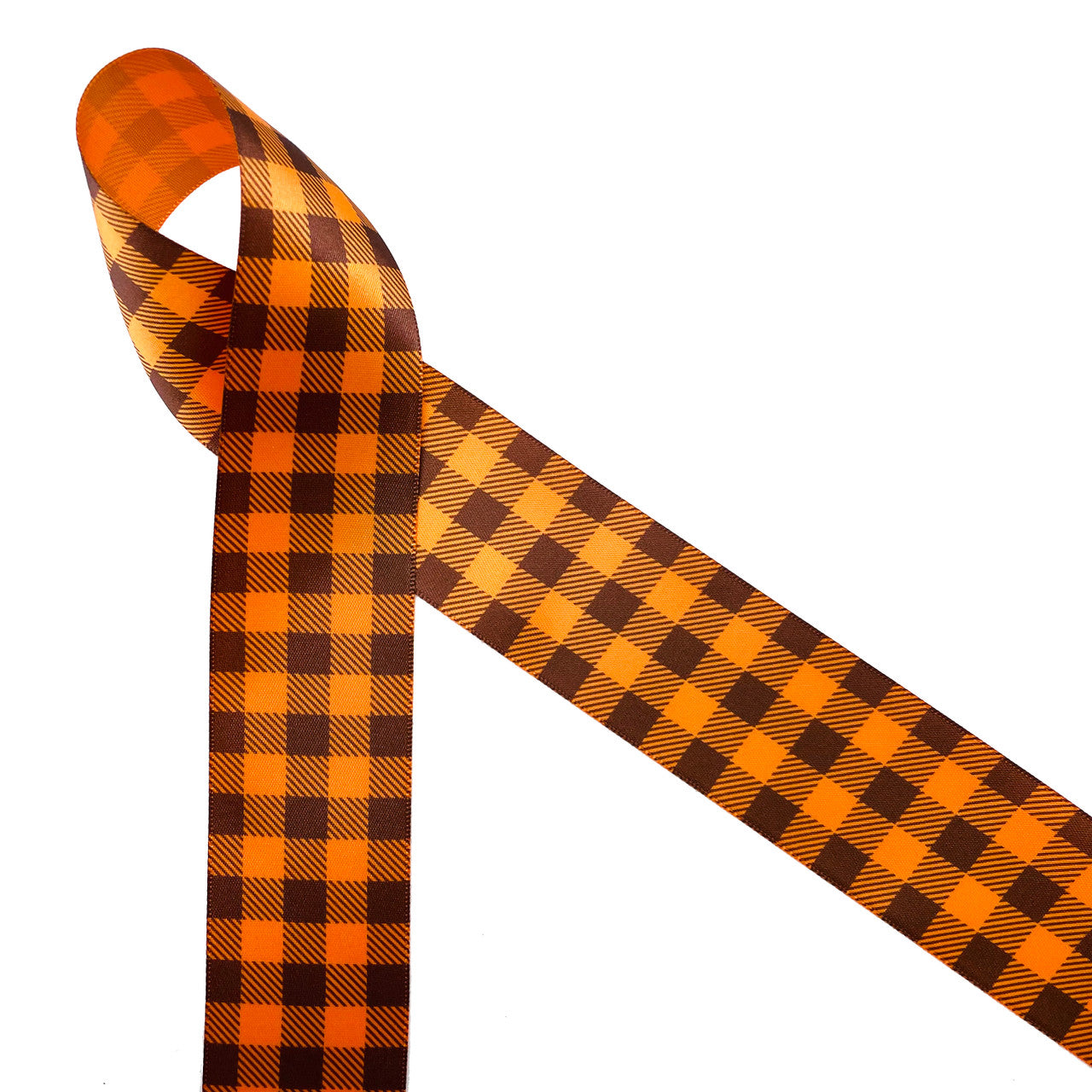 Gingham check in brown and orange printed on 1.5" tangerine single face satin ribbon is a Fall classic! This traditional plaid is ideal for Fall decor, wreath making, gift wrap, sewing, quilting and craft projects! Be sure to have this ribbon on hand for hair bows, head bands and hat bands to celebrate Autumn! All our ribbon is designed and printed in the USA