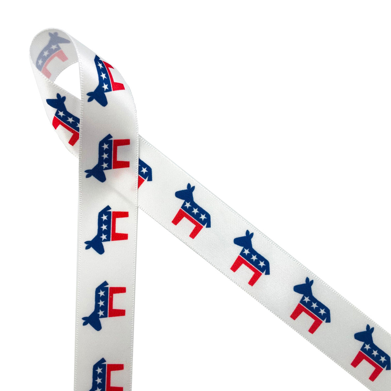 Democratic Donkey ribbon in red and blue with stars printed on 7/8" white single face satin is the ideal ribbon for election season events. This ribbon is perfect for Democratic fundraisers, rallies, conventions and parties. Use this ribbon for lapel pins, gift wrap, gift baskets, table decor, floral design, crafts, sewing and quilting projects. This ribbon is great for hair bows, head bands and fascinators too. All our ribbon is designed and printed in the USA