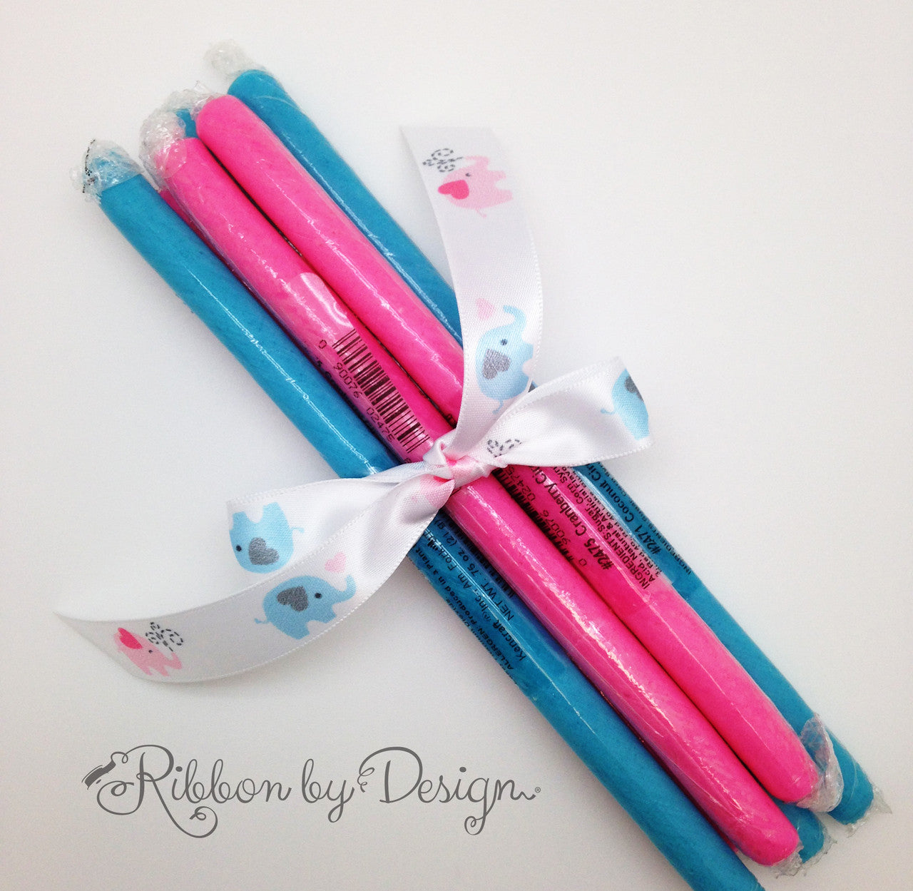 Pink and blue candy sticks are a fun favor for a baby reveal party!