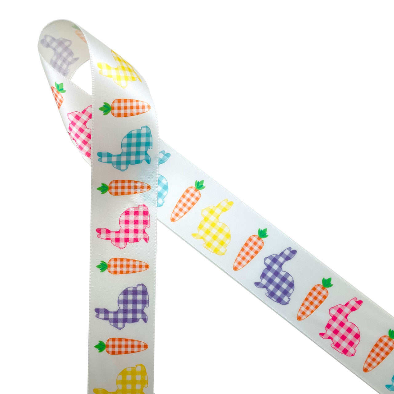 Gingham bunnies in pink, blue, purple and yellow with orange gingham carrots line up on 1.5" white single face satin creating a fun Easter ribbon for Easter baskets, Easter decor, gift wrap, wreaths, Spring decor, quilting, sewing and Spring crafting. All our ribbon is designed and printed in the USA