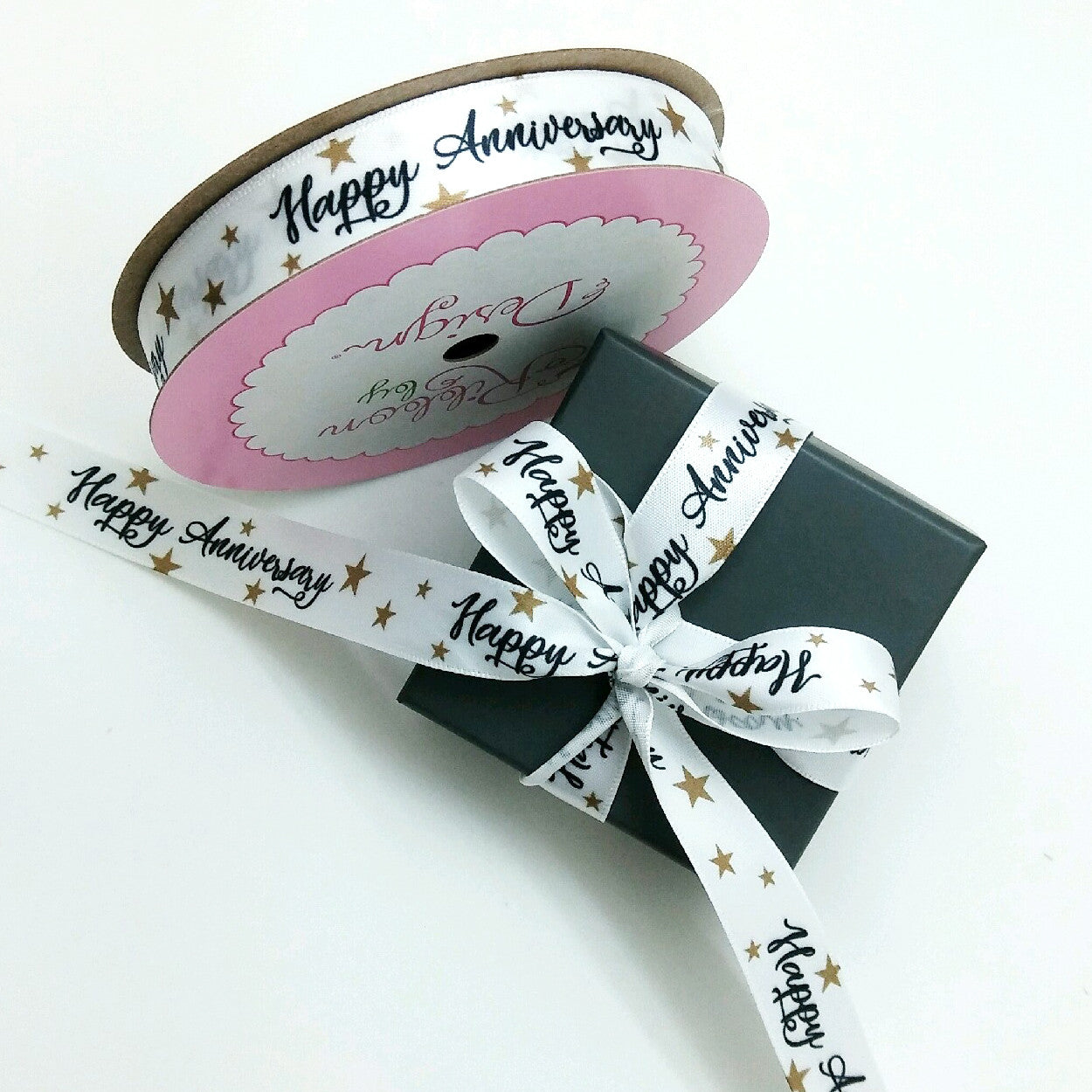 Happy Anniversary in black with gold stars on white single face satin makes this anniversary gift extra special!