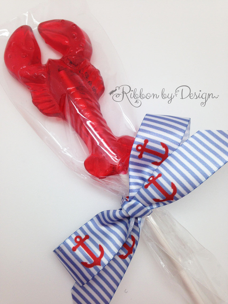 strips of red shiny ribbon and a bow over a white background with