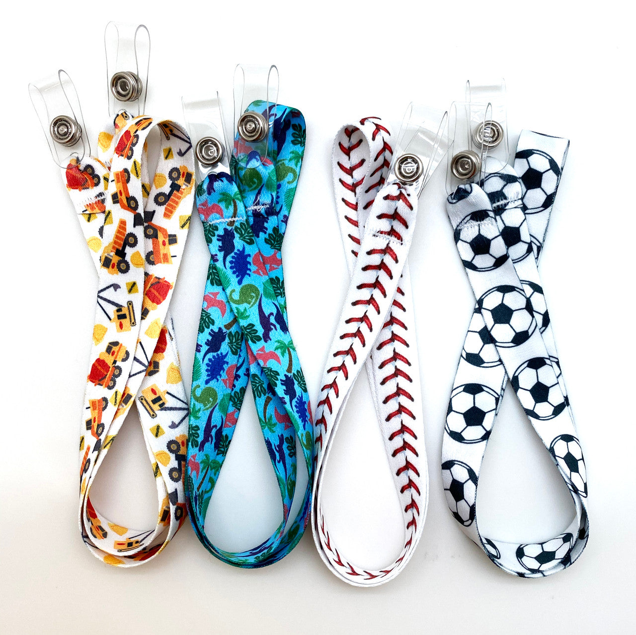 These lanyards are available in four fun designs for boys! Choose among construction vehicles, baseball stitch, dinosaurs, and soccer balls. Never lose a face mask at school, sports practice, on the bus or during lunch again!
