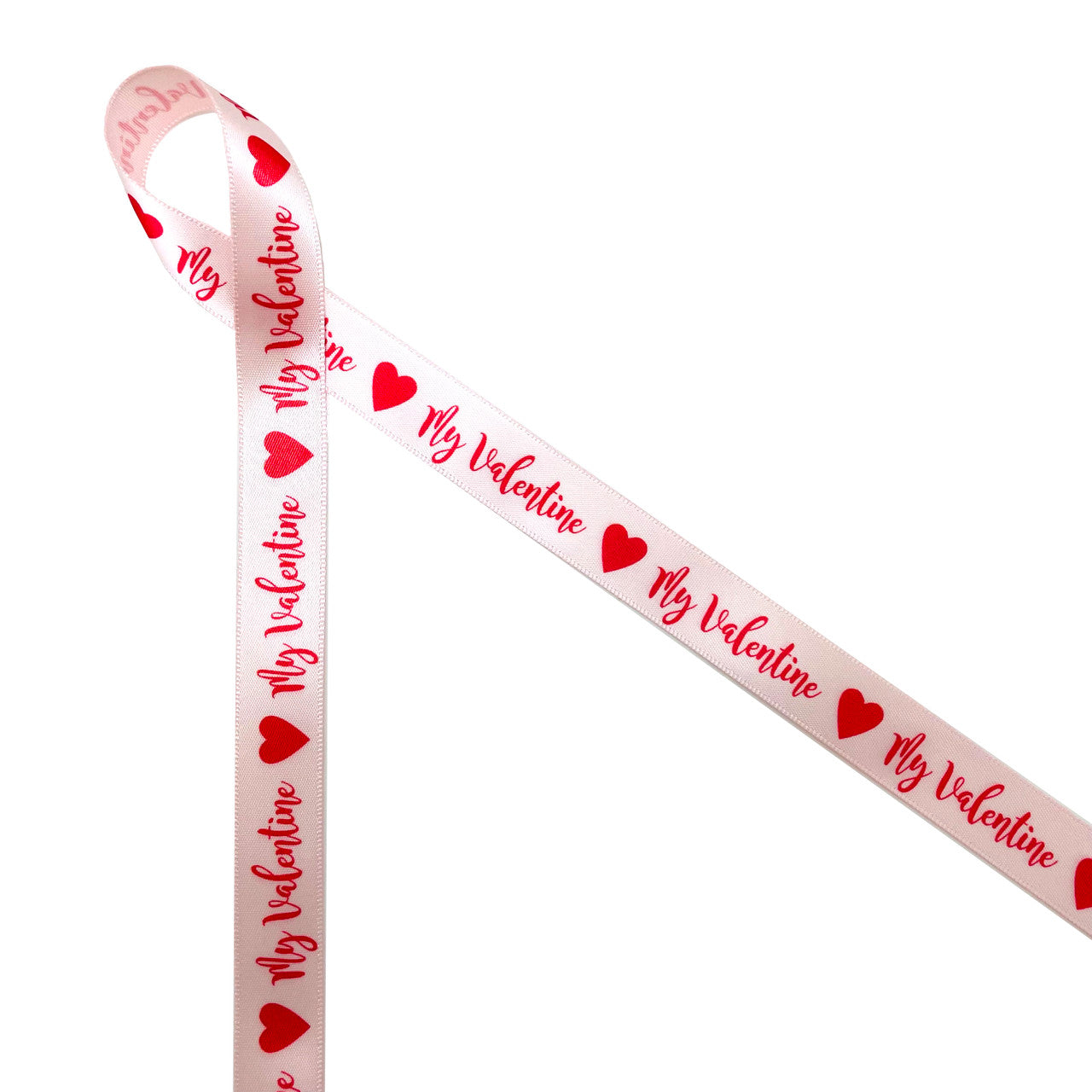 My Valentine in red with red hearts printed on 5/8" pink single face satin ribbon is a fun expression of love and affection for anyone on Valentine's Day. This is a fun ribbon for gift wrap, gift baskets, party favors, candy shops and chocolatiers. Use this ribbon on cookie favors, cake pops and sweets tables too! All our ribbon is designed and printed in the USA