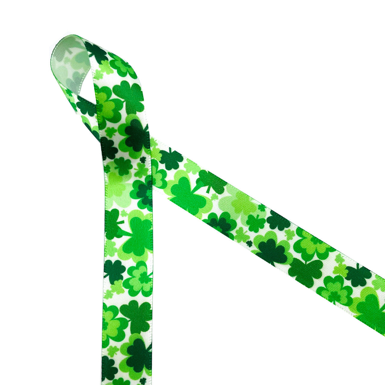 Our tossed shamrocks in multiple shades of green on 5/8" white single face satin ribbon will make all your St. Patrick's favors and treats pop with the wearn' of the green! Use this ribbon for party favors, gift wrap, gift baskets, party decor , cookies and sweet treats Designed and printed in the USA
