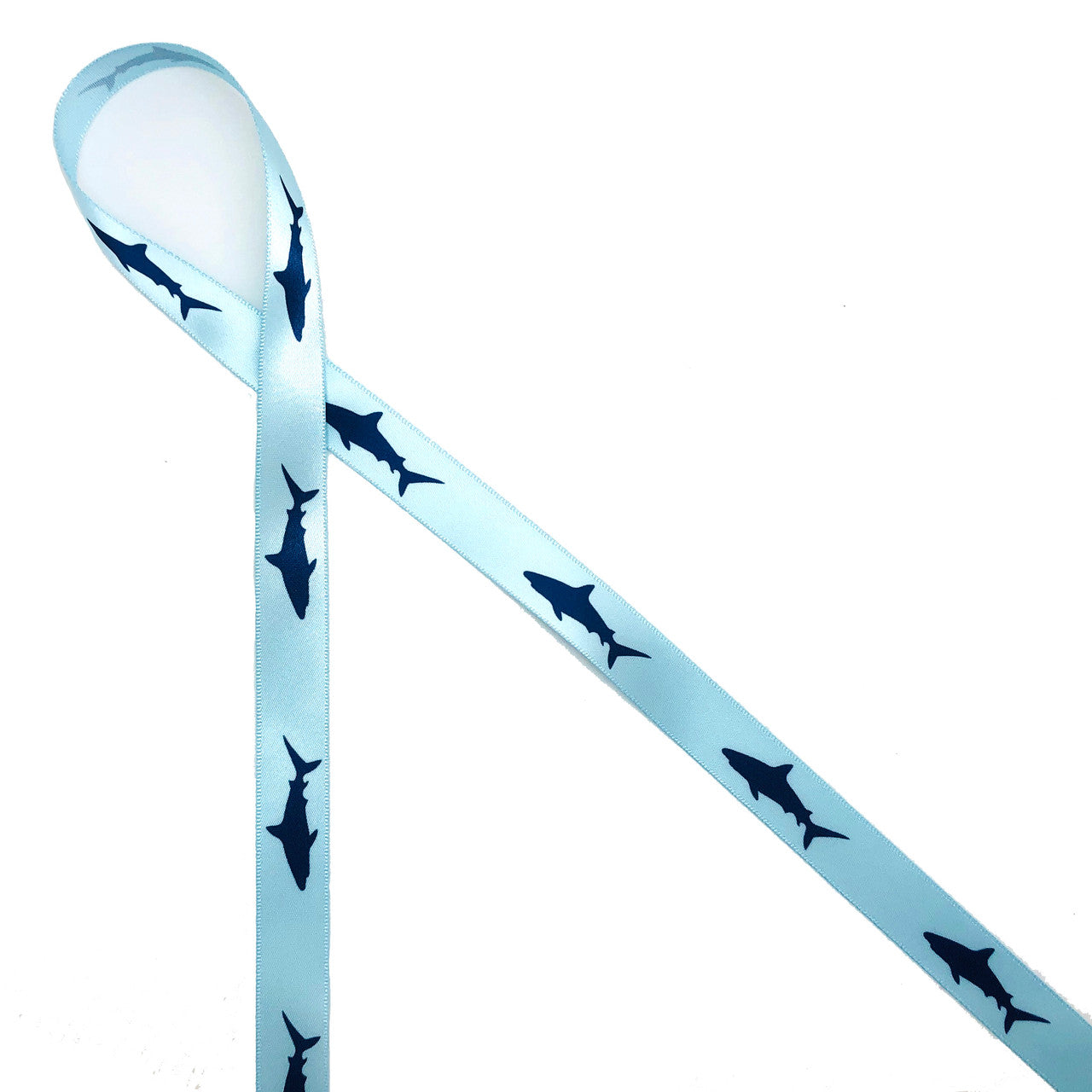 Navy blue shark silhouettes printed on 5/8" light blue ribbon is such a fun design for birthday parties, Shark Week and lots of Summer themed events! Our ribbon is designed and printed in the USA