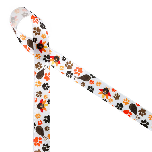 Pet Thanksgiving ribbon features paw prints in gold, orange, black and brown along with a delicious turkey leg and adorable turkey. Printed on 5/8" white single face satin ribbon, this is an ideal ribbon for any one who makes special pet treats!