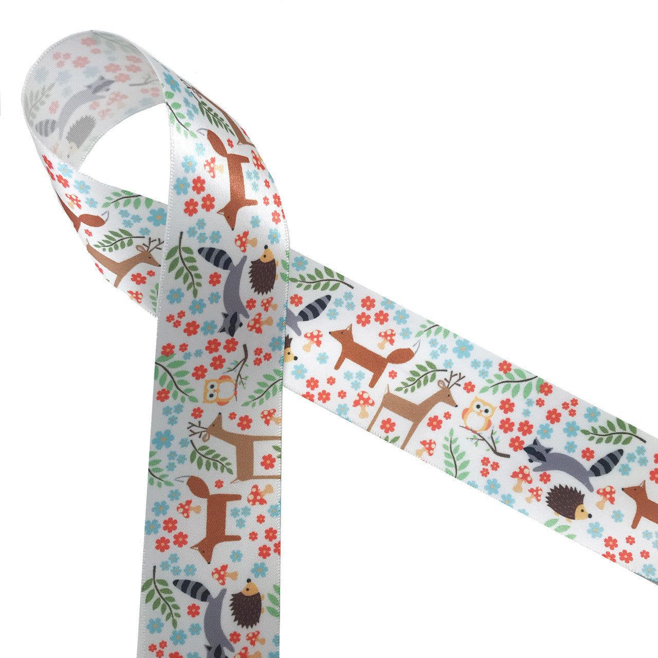 Woodland animals on1.5" white satin ribbon feature raccoon, deer, fox, owls and hedgehogs scattered among leafy branches, flowers and mushrooms! This is a great ribbon for baby showers, nurseries, gift wrap, quilting  and first birthday parties. Our ribbon is designed and printed in the USA