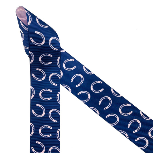 Horse shoes in pink tossed on a navy blue  background printed on  1.5" pink grosgrain ribbon is an ideal ribbon for any horse and equestrian themed craft, sewing and quilting project. This is a great ribbon for hair bows for pony finals, head bands and ribbons for decor. Use this ribbon for gift wrap, gift baskets, party decor and awards with an equestrian theme. All our ribbons are designed and printed in the USA