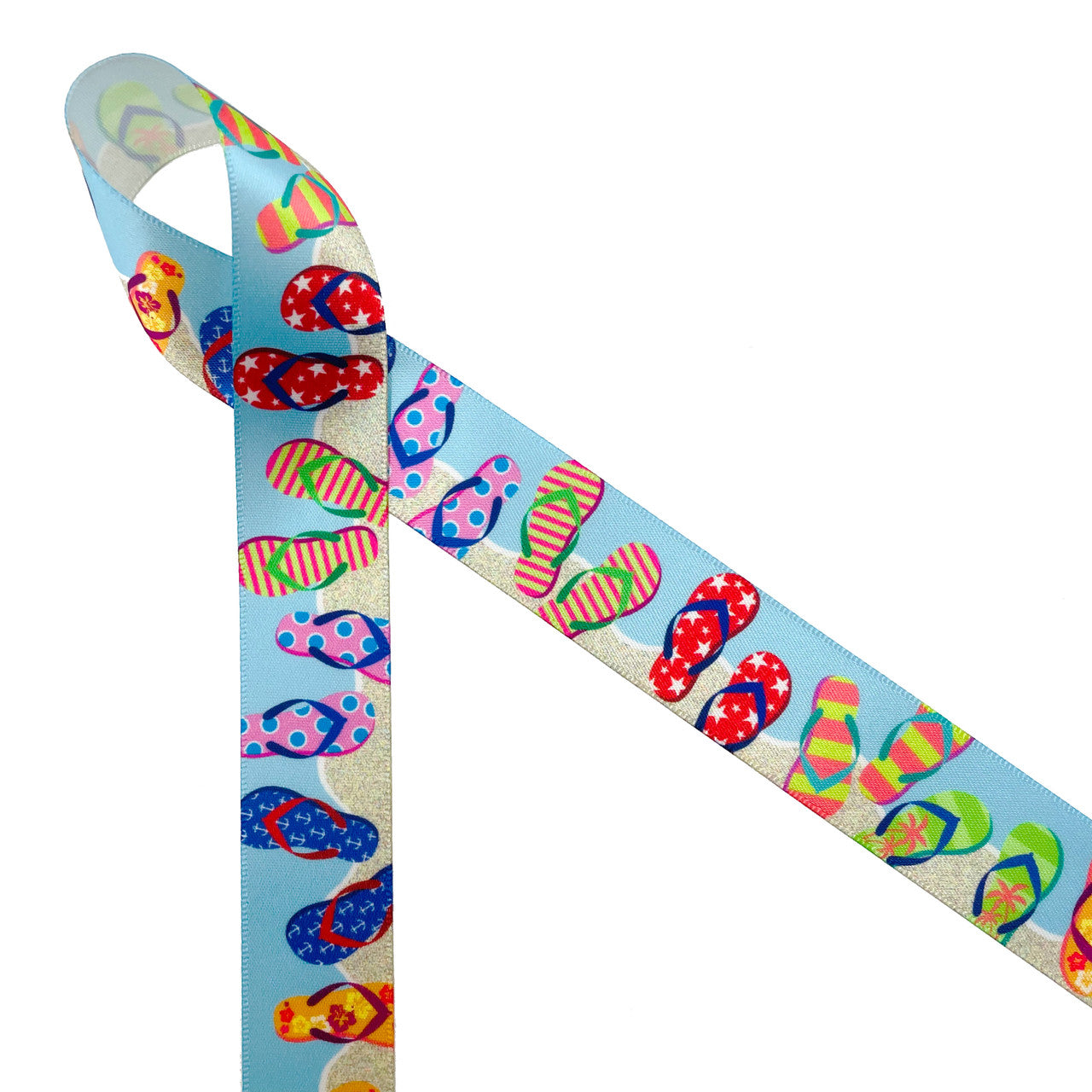 Flip Flop ribbon featuring colorful sandals with stripes, stars, florals and palm trees in red, yellow, orange. blue and green on a sandy background with blue skies printed on 7/8" white single face satin is such a fun Summer ribbon. This beautiful ribbon is perfect for beach parties, pool parties, Summer themed parties, gift wrap, gift baskets, party decor and party favors. Use this ribbon for crafts, sewing, quilting and hair bow ribbons too! All our ribbons are designed and printed in the USA